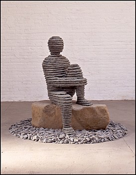 Boaz Vaadia Eli'av (1997), a bronze and bluestone sculpture depicting a seated human figure on a natural boulder, surrounded by stones. This modern figurative stone sculpture exemplifies Vaadia&acirc;s distinct artistic approach. Available at Sponder Gallery.