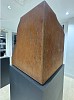 A sculptural view of Alembic Cube (Study 1) (2016) by Jonathan Prince, featuring the rusted, textured surface of CorTen steel. The cubeâ€™s precise geometry contrasts with the softened, eroded edges, creating a tension between structure and organic evolutio