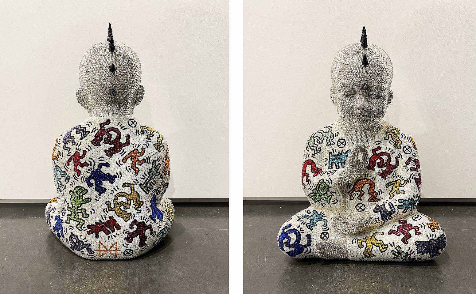Metis Atash, Soul Sync, 2025
Resin, acrylic paint and 28,000 Swarovski crystals, 17 x 12 x 7 in.
A cast resin Punk Buddha sculpture with imagery inspired by Keith Haring created using over 28,000 swarovski crystals 
ATAS00262